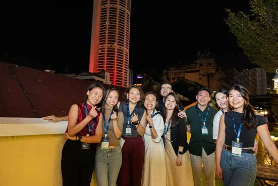Young participants together at night in George Town